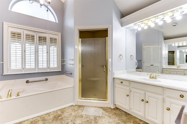 bathroom with separate shower and tub, vanity, and a textured ceiling