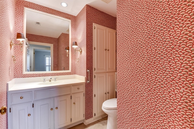 bathroom with vanity and toilet