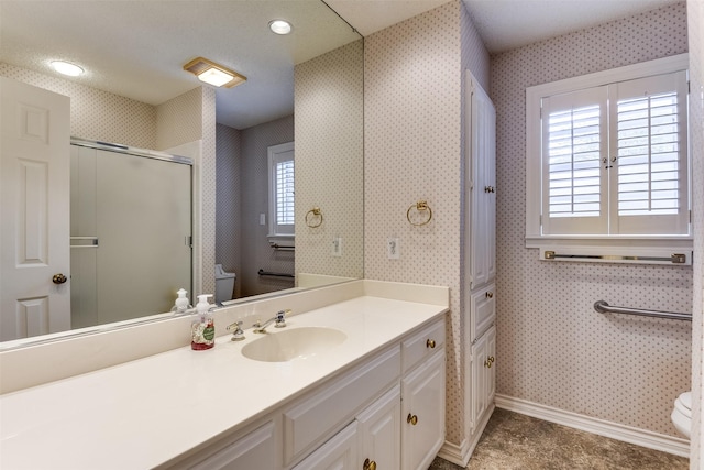 bathroom featuring tile patterned flooring, walk in shower, vanity, and toilet