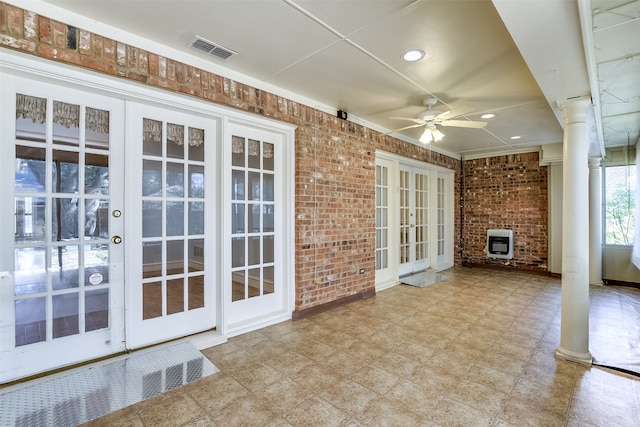 view of patio / terrace with french doors, heating unit, and ceiling fan