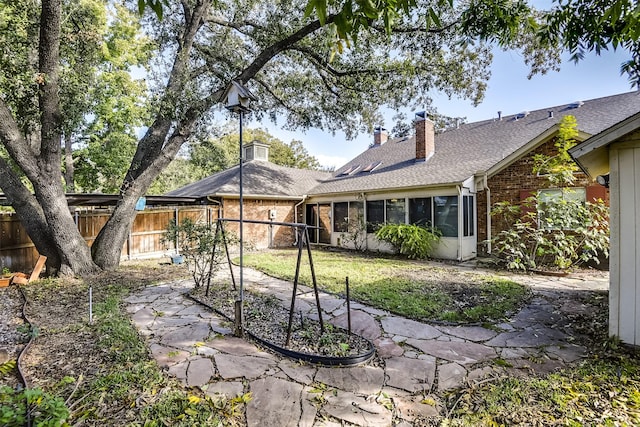 back of house featuring a yard