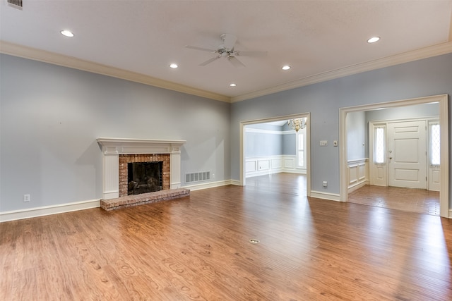 unfurnished living room featuring ceiling fan, light hardwood / wood-style floors, and ornamental molding