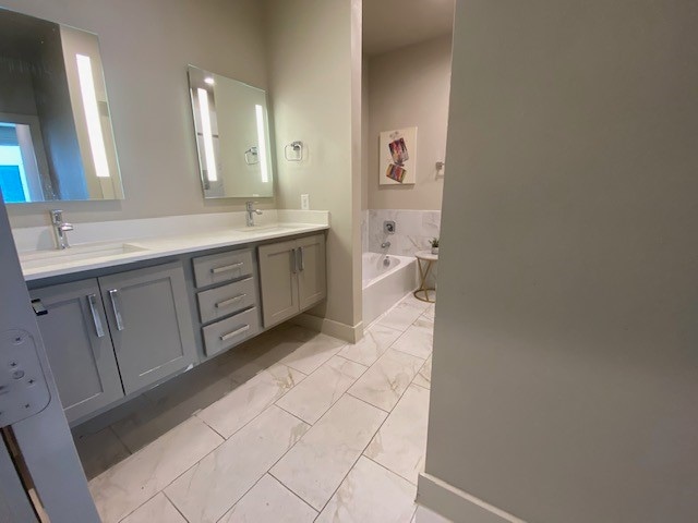 bathroom featuring a tub to relax in and vanity