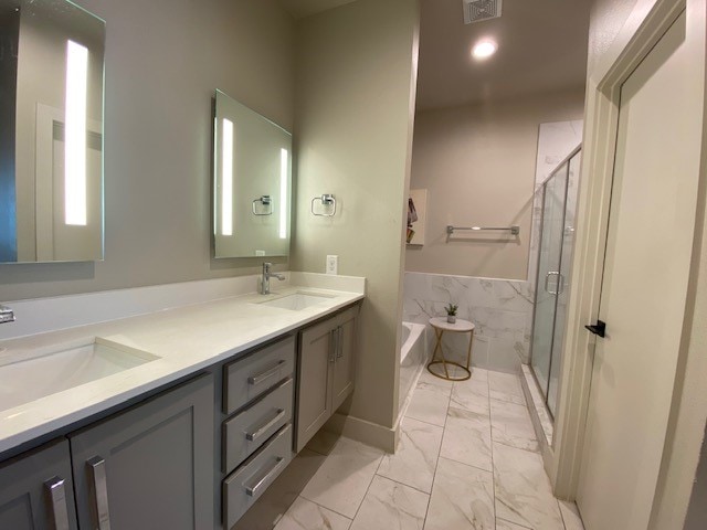 bathroom featuring vanity and separate shower and tub