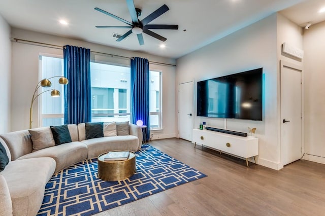 living room featuring visible vents, a ceiling fan, wood finished floors, recessed lighting, and baseboards