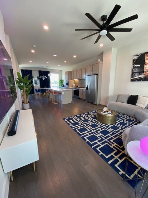 living room featuring dark hardwood / wood-style floors and ceiling fan