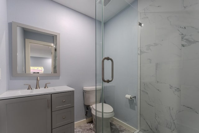 bathroom featuring vanity, toilet, and a shower with door