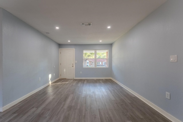 empty room featuring dark wood-type flooring