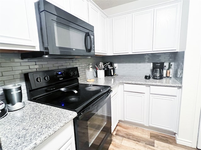 kitchen featuring black appliances, light stone countertops, tasteful backsplash, light hardwood / wood-style floors, and white cabinetry