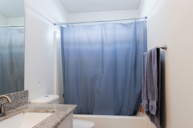 full bathroom featuring a textured ceiling, vanity, shower / tub combo, and toilet