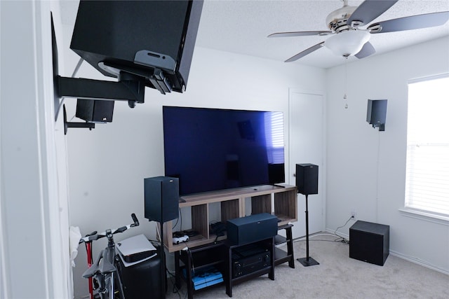 carpeted home office featuring ceiling fan