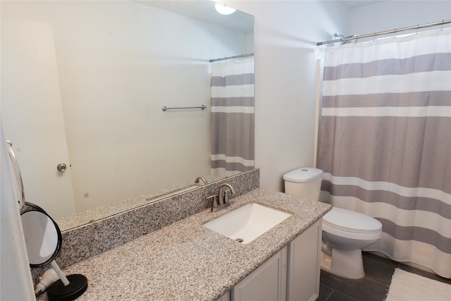 bathroom with tile patterned floors, vanity, and toilet