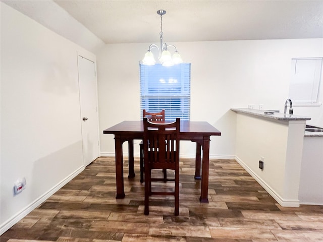 dining space featuring an inviting chandelier and dark wood-type flooring