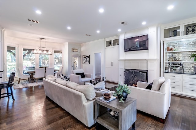 living room featuring a chandelier and dark hardwood / wood-style flooring