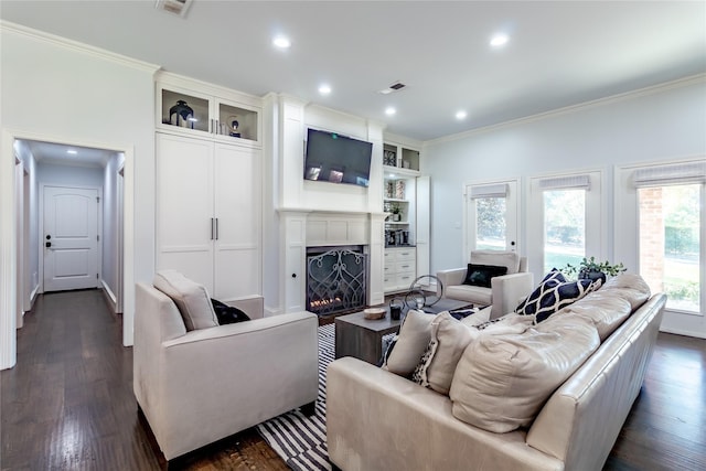 living room with dark hardwood / wood-style flooring and crown molding