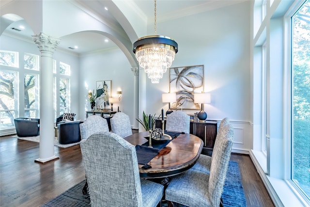 dining area featuring dark wood-type flooring, a healthy amount of sunlight, and an inviting chandelier