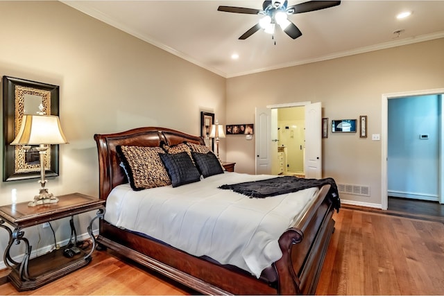 bedroom featuring ceiling fan, hardwood / wood-style floors, and crown molding