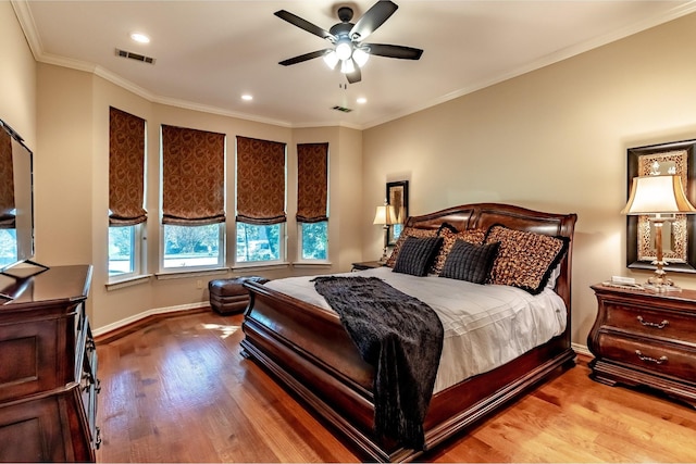 bedroom featuring ceiling fan, light wood-type flooring, and crown molding