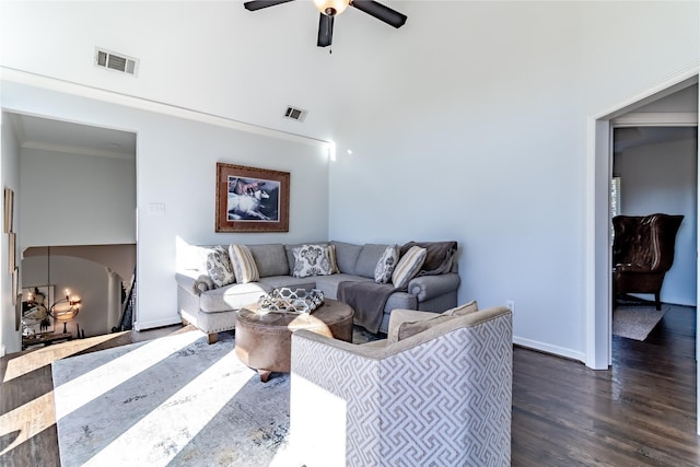 living room featuring ceiling fan with notable chandelier, dark hardwood / wood-style floors, and crown molding