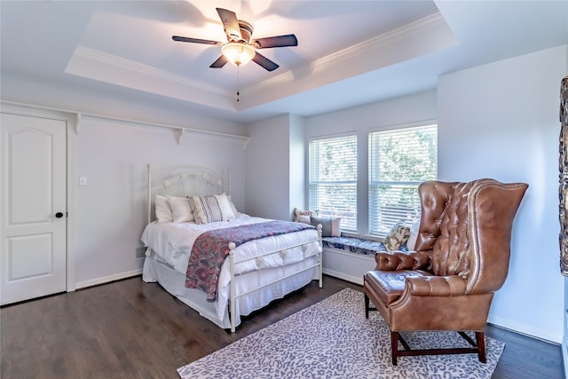 bedroom featuring a tray ceiling and dark wood-type flooring