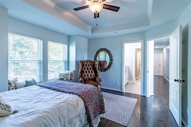 bedroom with ensuite bathroom, crown molding, ceiling fan, a tray ceiling, and dark hardwood / wood-style flooring