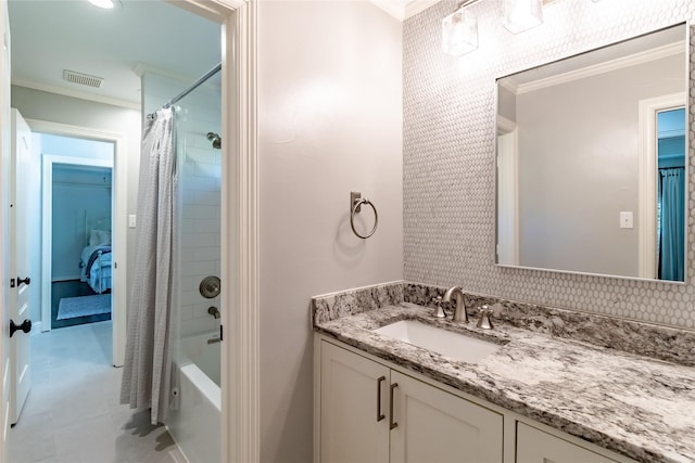 bathroom with shower / bath combo with shower curtain, vanity, tasteful backsplash, and ornamental molding