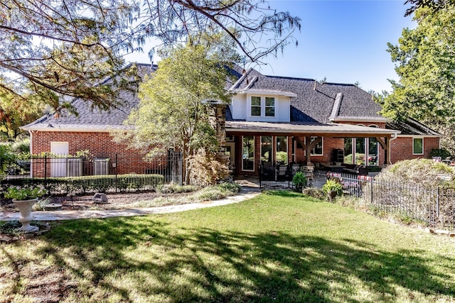 back of house with a patio and a lawn