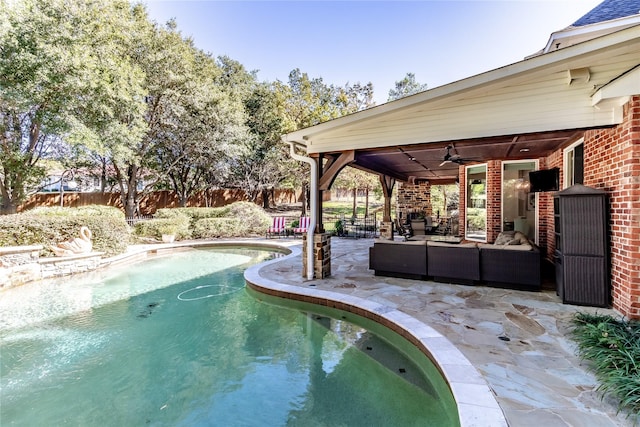 view of pool with outdoor lounge area, a patio, and ceiling fan