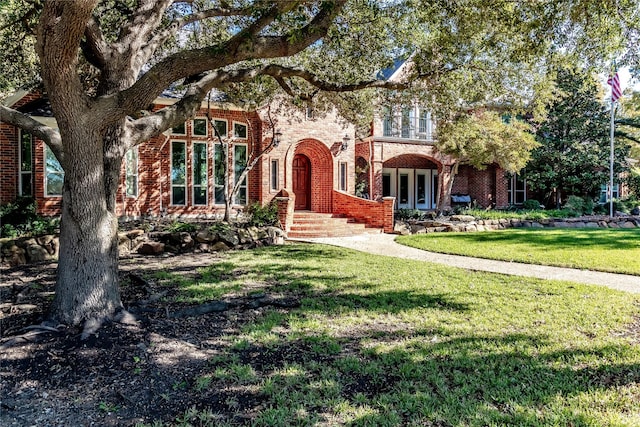 view of front of house featuring a front yard and french doors