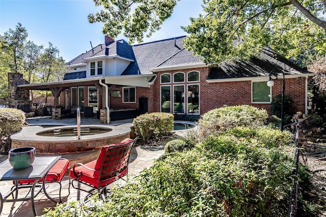 rear view of house featuring a patio