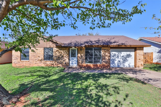 ranch-style home featuring a garage and a front lawn