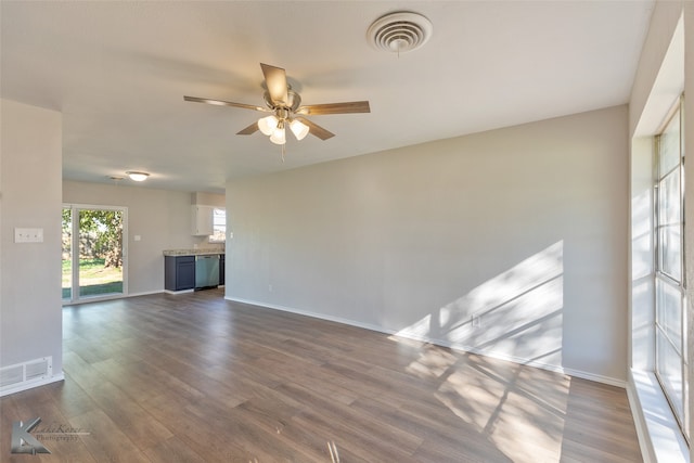 empty room with ceiling fan and dark hardwood / wood-style floors