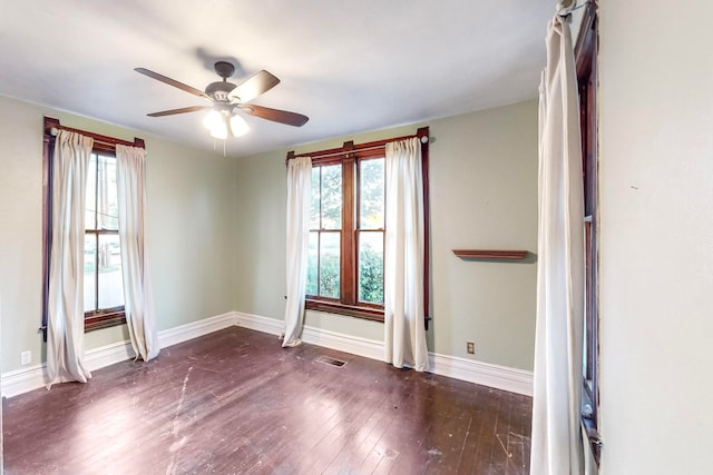 empty room with ceiling fan and dark wood-type flooring