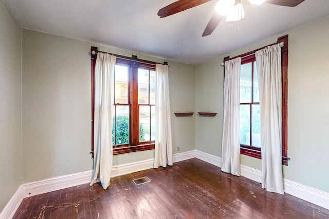 unfurnished room with ceiling fan and dark hardwood / wood-style floors