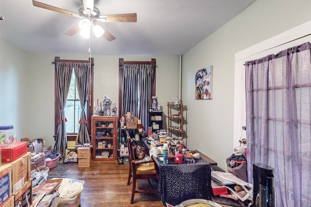 home office with dark hardwood / wood-style floors and ceiling fan