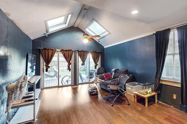 home office featuring wood-type flooring, lofted ceiling with skylight, and ceiling fan