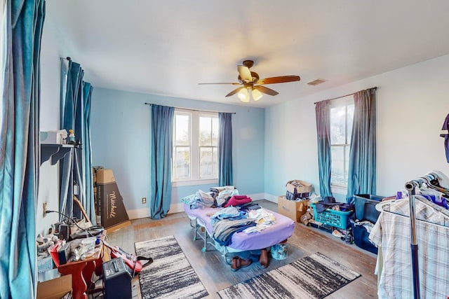 bedroom with light hardwood / wood-style flooring and ceiling fan