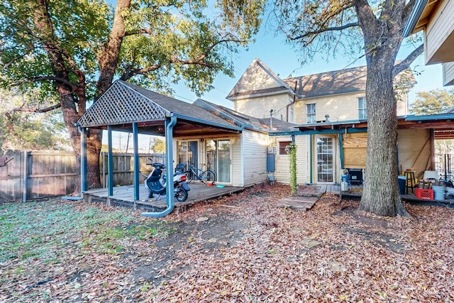 back of house featuring a wooden deck