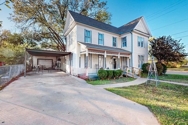 view of front of house featuring covered porch and a carport