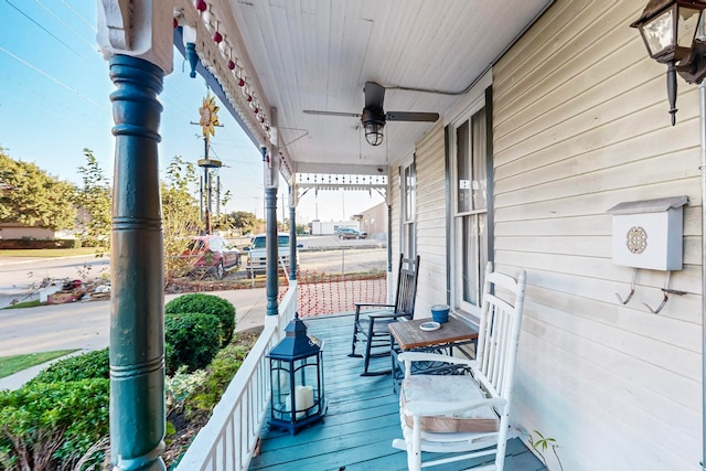 deck with covered porch and ceiling fan