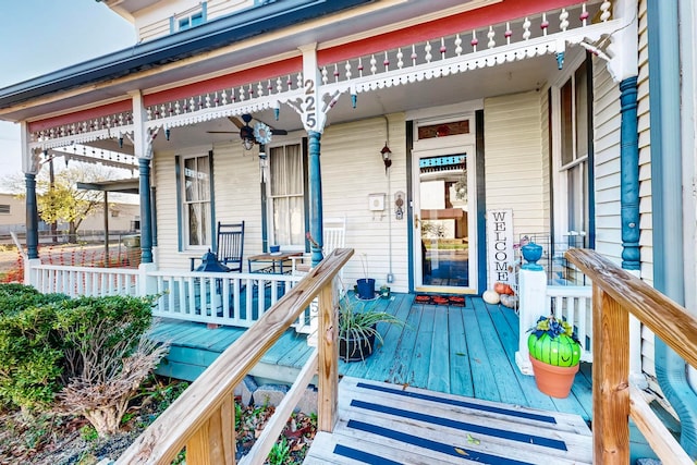 wooden terrace with ceiling fan and a porch