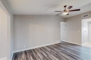 spare room featuring dark hardwood / wood-style flooring and lofted ceiling