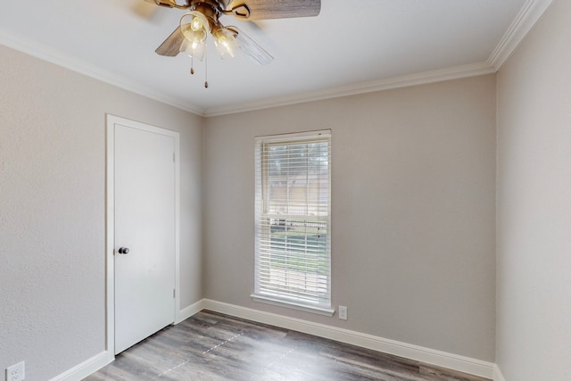 empty room featuring ceiling fan, baseboards, wood finished floors, and ornamental molding