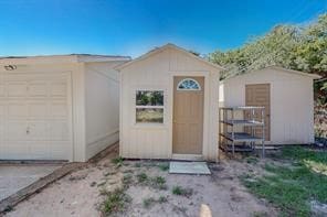 view of front of home featuring a storage shed