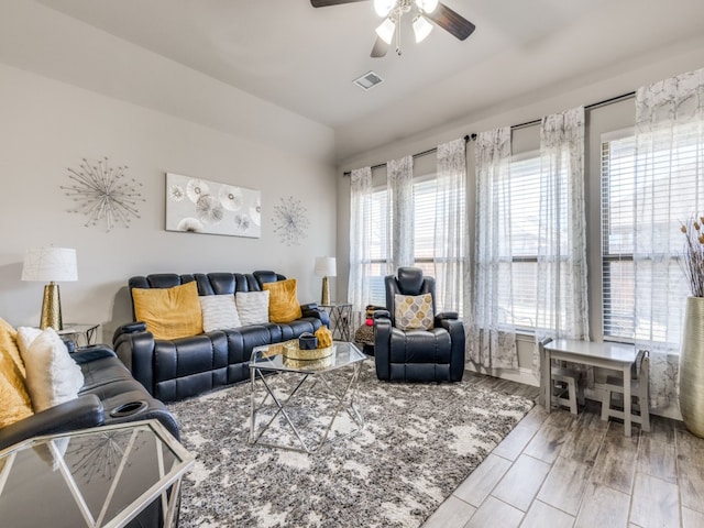 living room with light hardwood / wood-style floors, a wealth of natural light, and ceiling fan