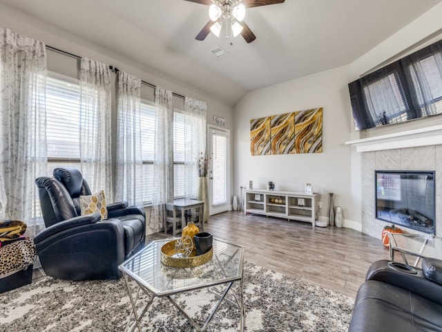 living room featuring hardwood / wood-style floors, ceiling fan, and lofted ceiling