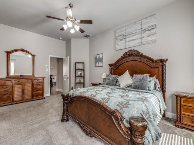 bedroom featuring light carpet and ceiling fan