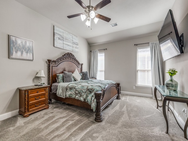 bedroom featuring ceiling fan, light carpet, and vaulted ceiling