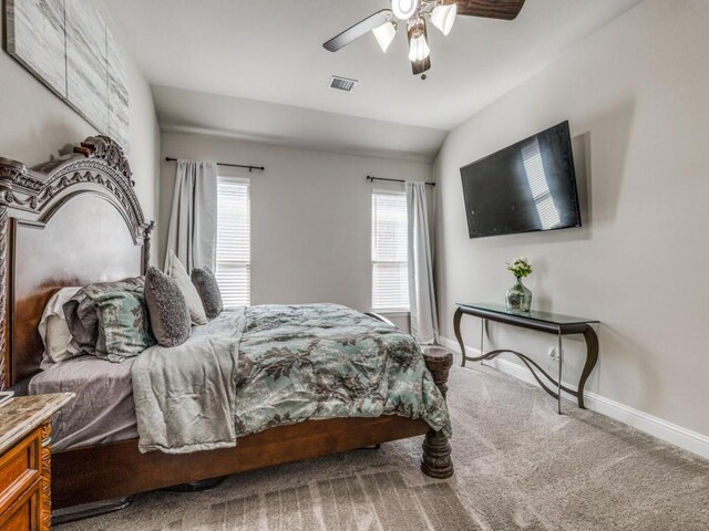 carpeted bedroom with ceiling fan and lofted ceiling