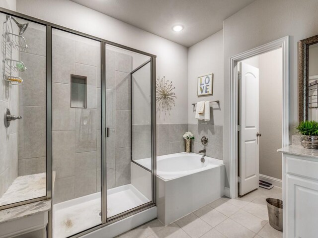 bathroom featuring separate shower and tub, tile patterned flooring, and vanity